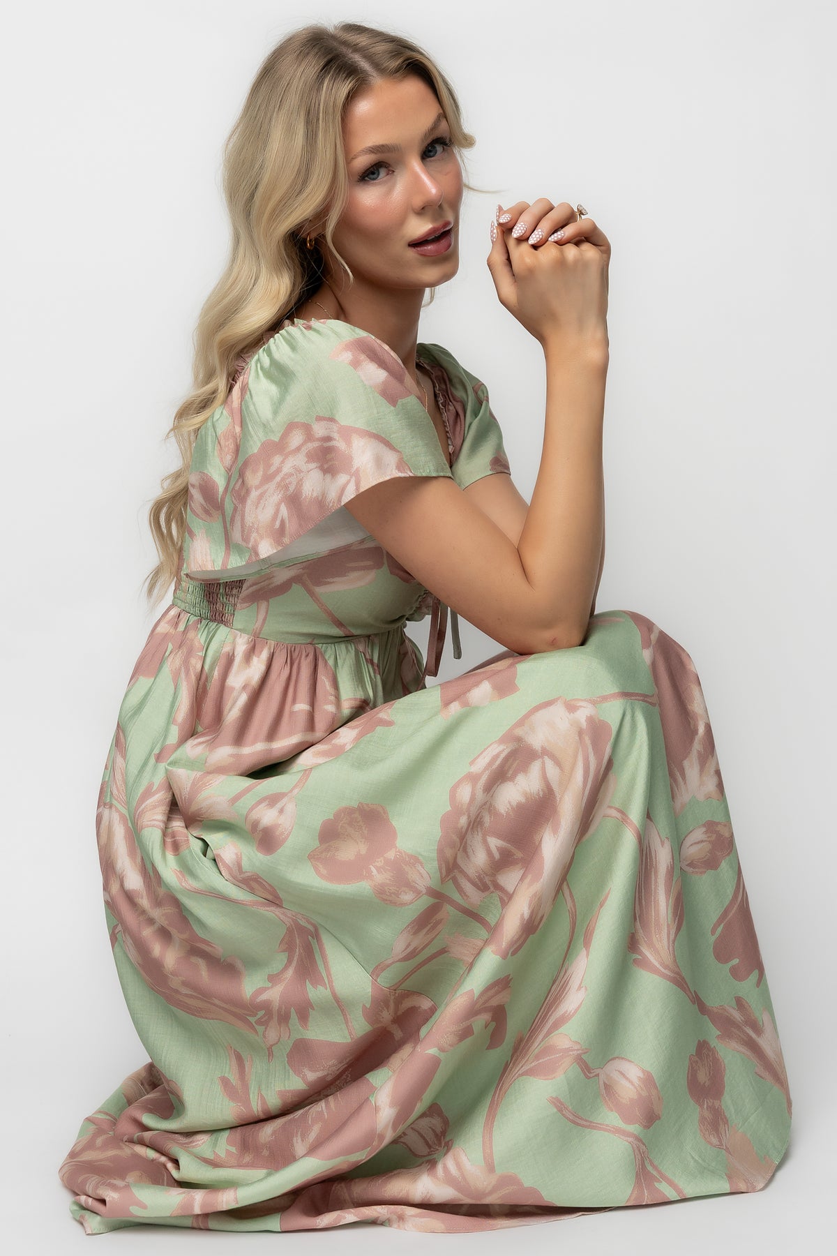 Studio flat-lay of the Eliana Maxi Dress displaying the overall floral pattern, fabric drape, and fully lined body construction with unlined sleeves.