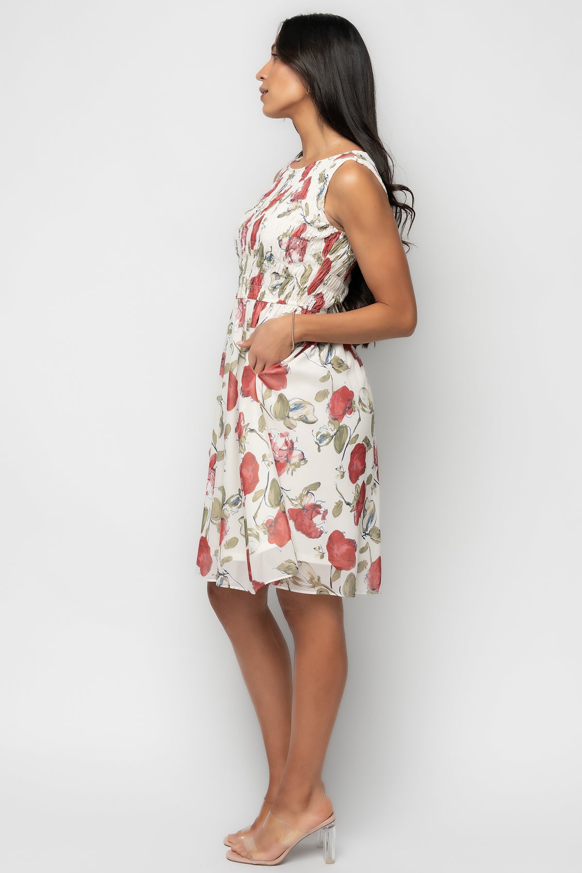 Lifestyle image of the Clémence dress styled with sandals, emphasizing short length, A-line movement, and floral pattern.
