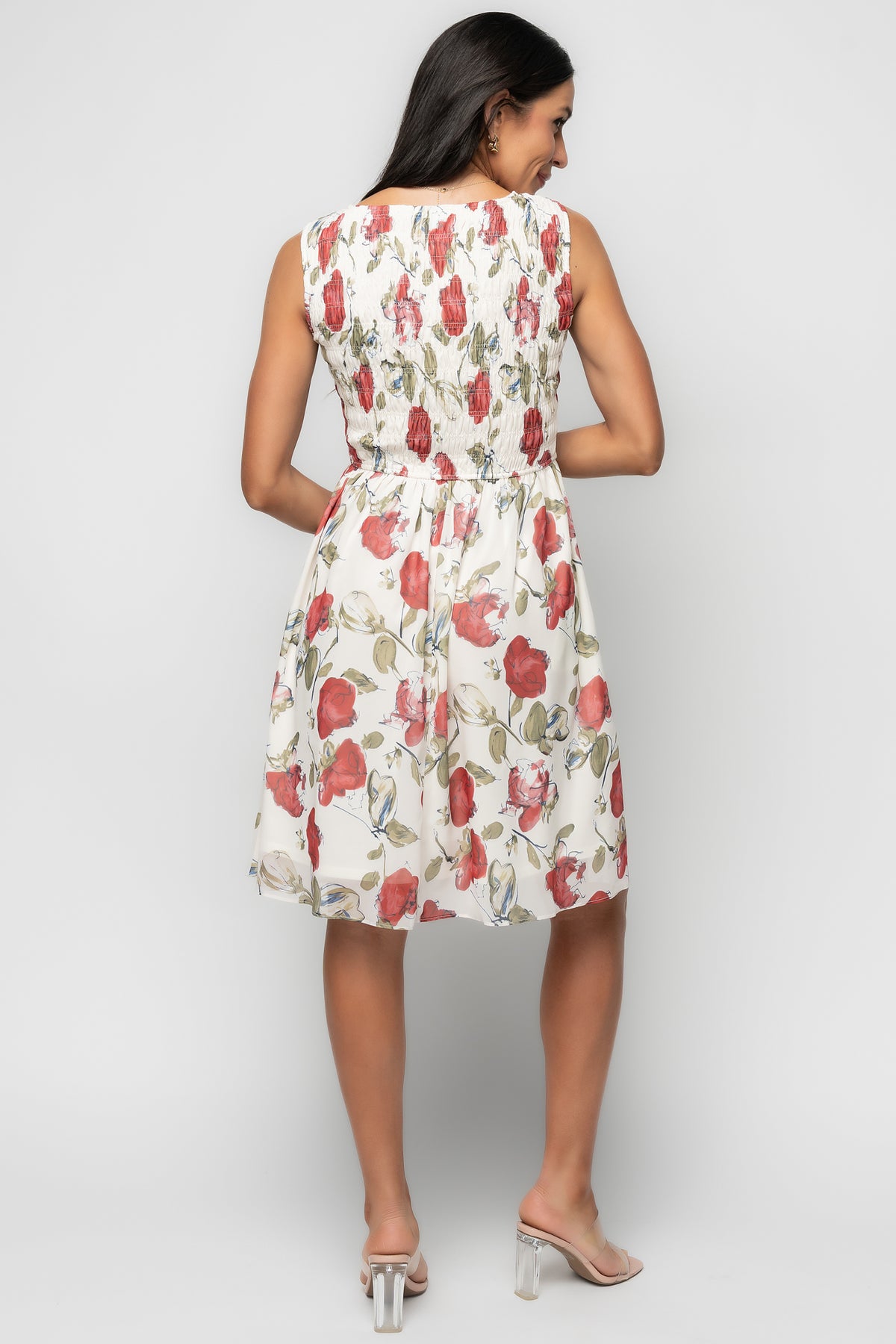 Close-up of smocked bodice and high round neckline on the rose floral Clémence dress, showing texture and elastic detail.