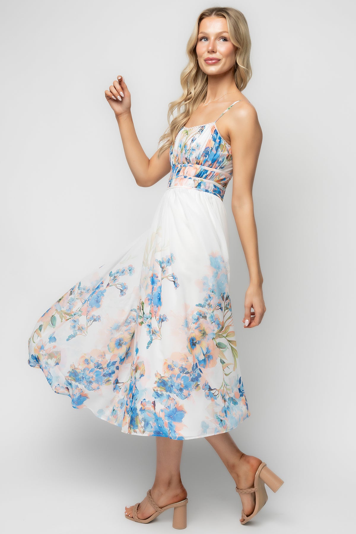 Styled full-length photo of model wearing the Marceline midi dress, showing the flowy skirt, midi silhouette, and fully lined construction.