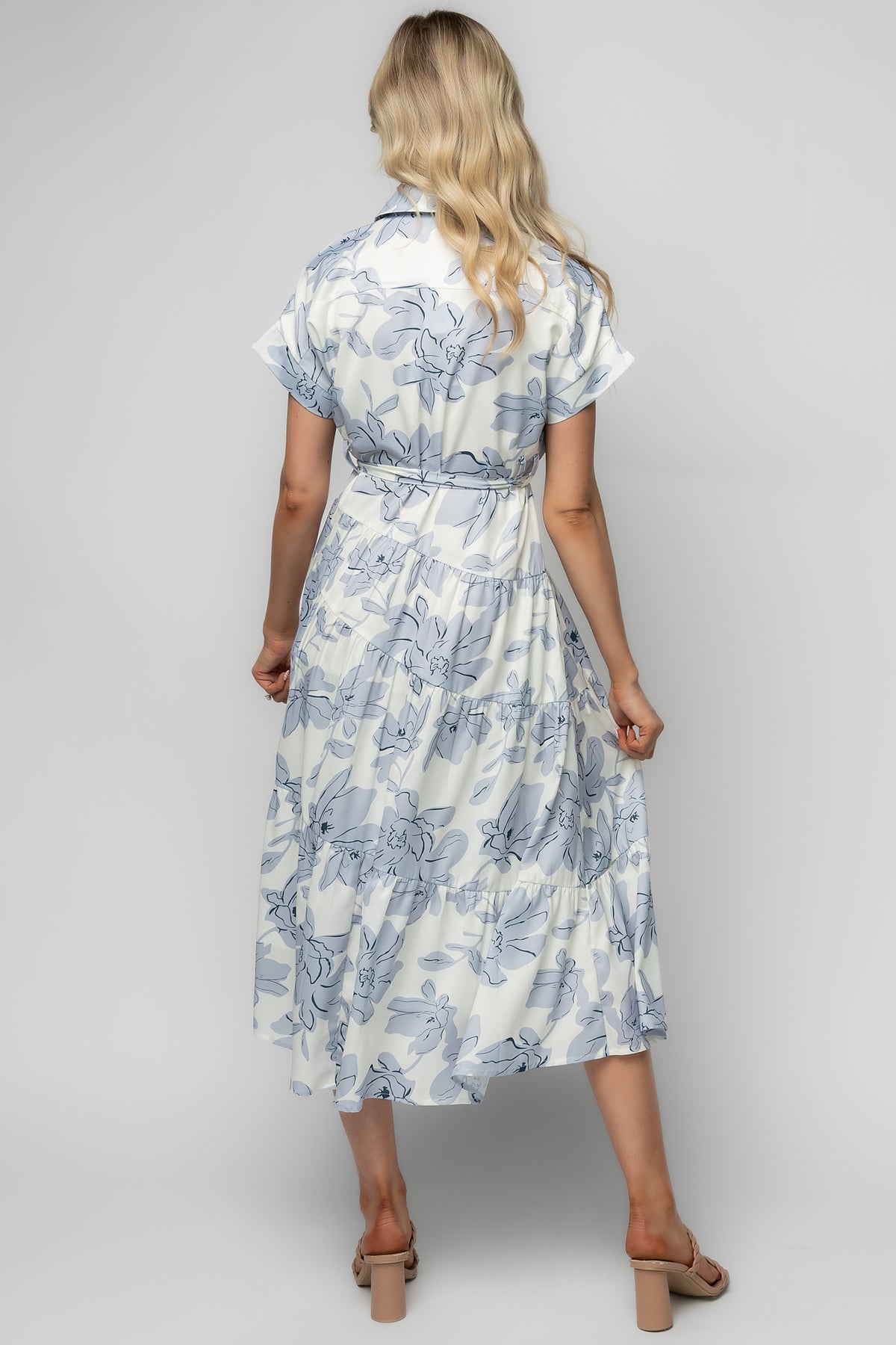 Back view of dress showing fully lined construction, mid-calf length, and subtle floral placement on an ivory base.
