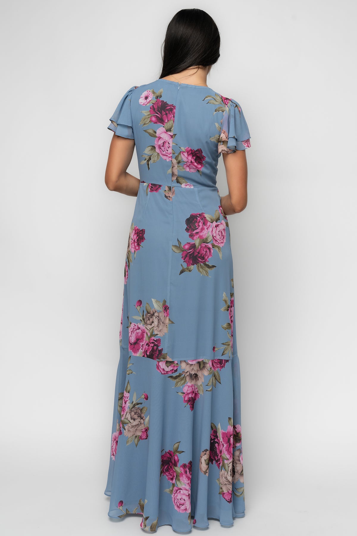Back view of the Willa Maxi Dress in slate blue floral, displaying the back zipper and the dress’s lined skirt and unlined sleeves.