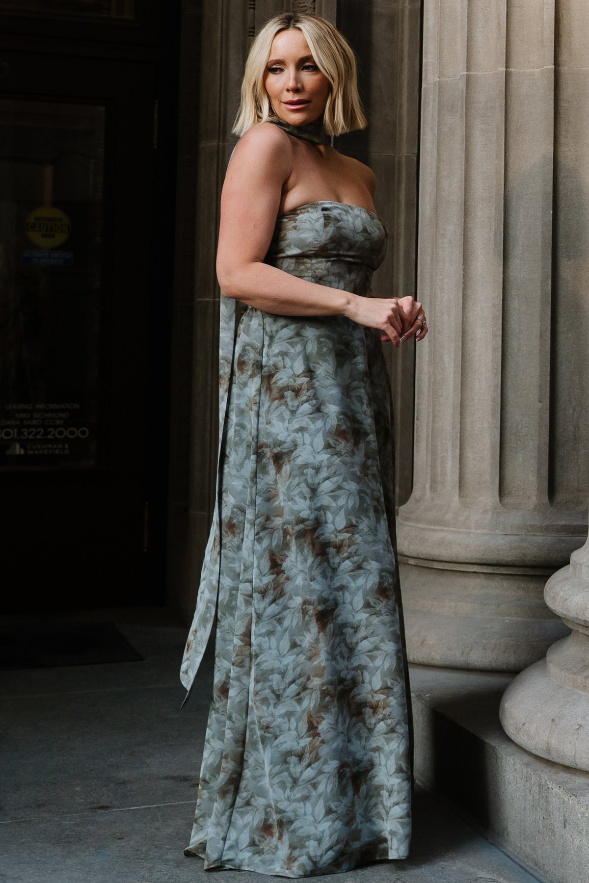 Back view of Florian strapless maxi dress showing smocked back bodice and gathered skirt in eucalyptus green floral chiffon.