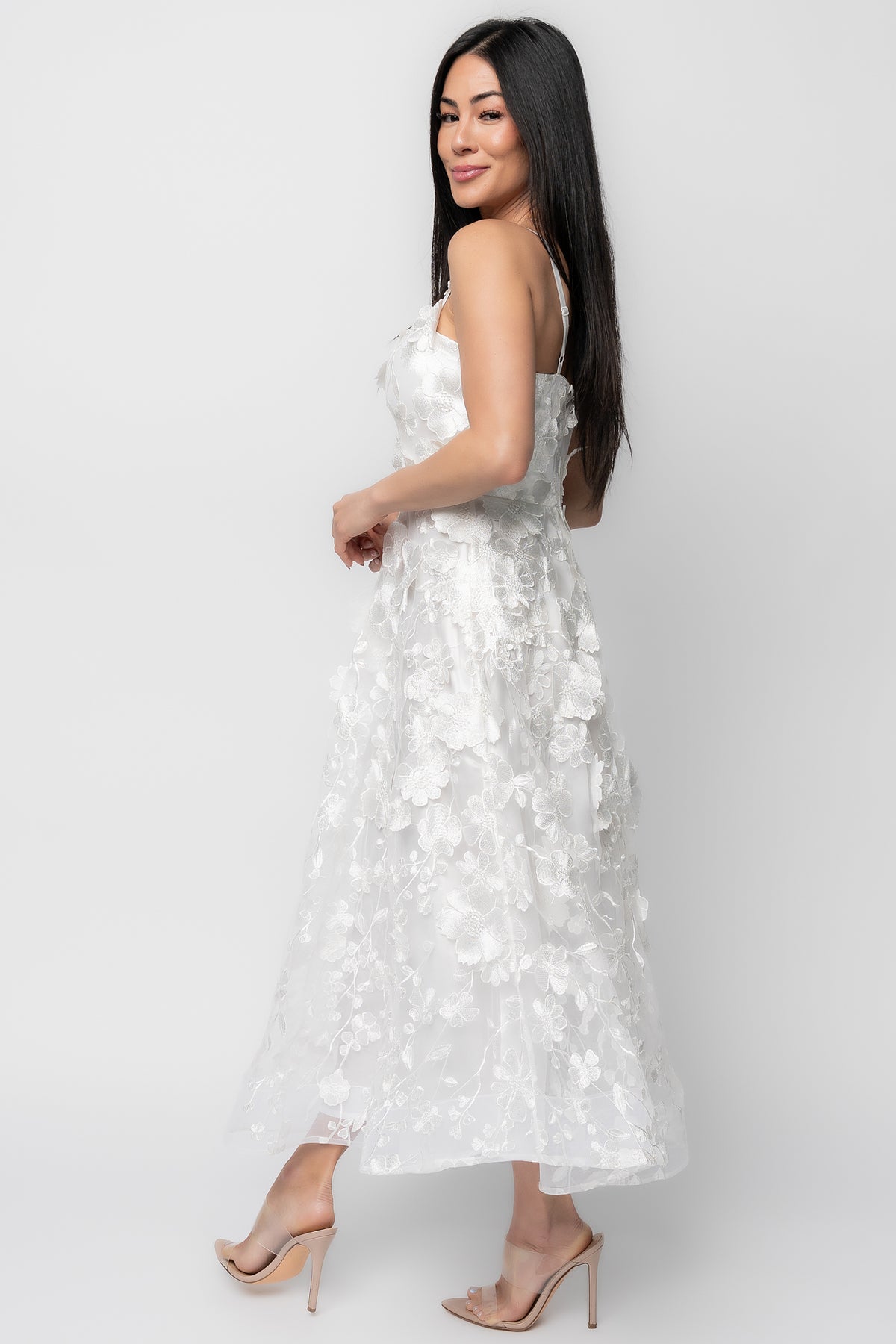 Detail of the square neckline with silicone grip and adjustable strap hardware on the ivory mesh dress.