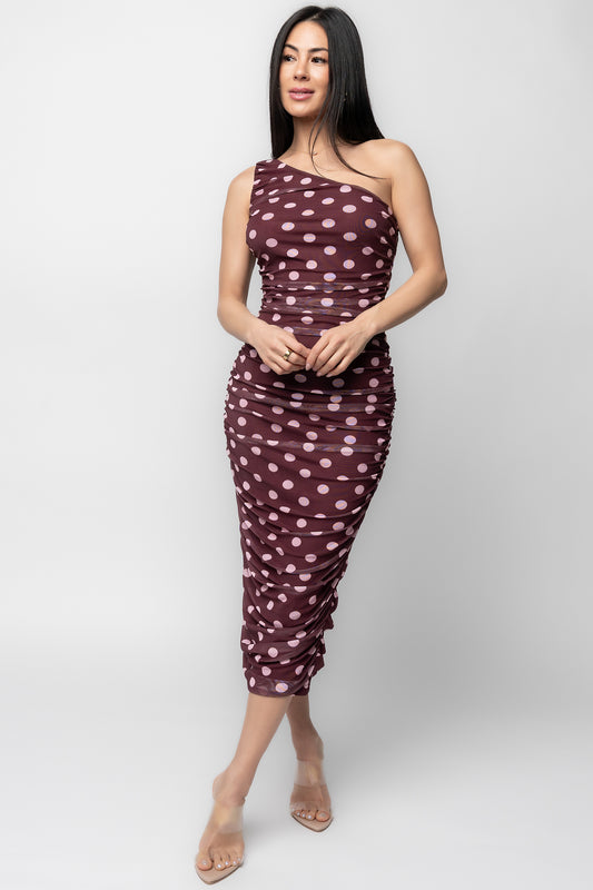 Front view of berry one-shoulder midi dress with soft pink polka dots, elastic asymmetric neckline and ruched sides.