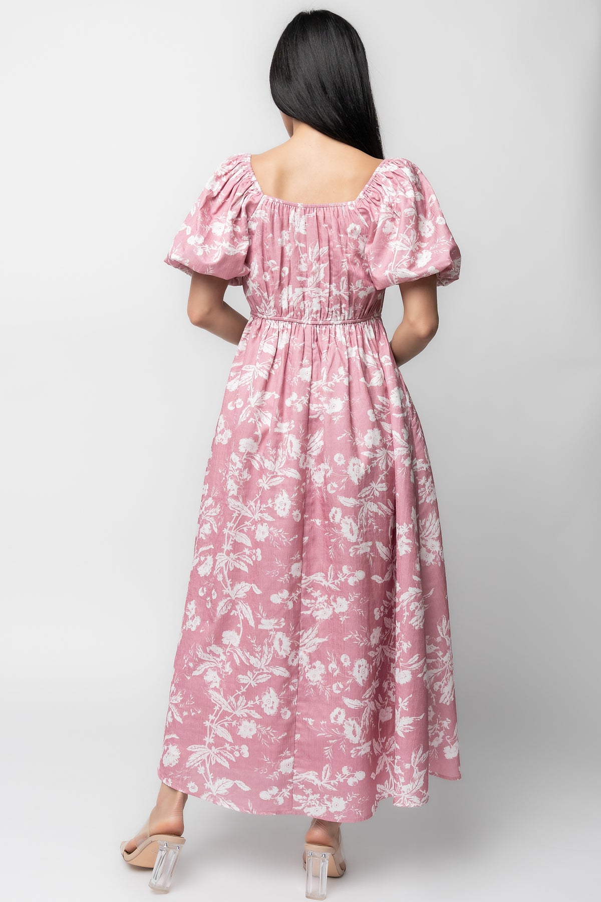 Back view showing bloused back, stretch elastic waist detail, and full A-line skirt in pink with white florals.