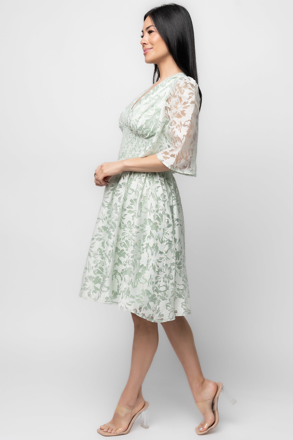 Back view of the Bonnie Short Dress showing back zipper with smocking and the fitted smocked empire waist in light sage floral.