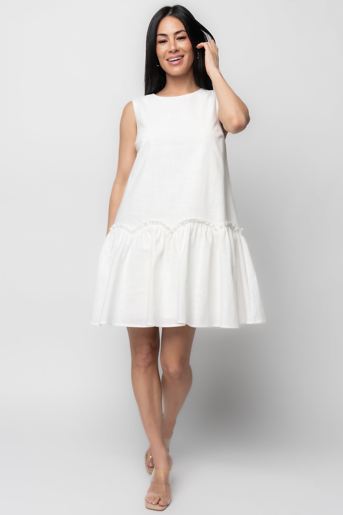 Front view of Paulina Short Dress in off-white textured cotton, showing round neckline, tank sleeves, and scalloped ruffle tier for feminine movement.