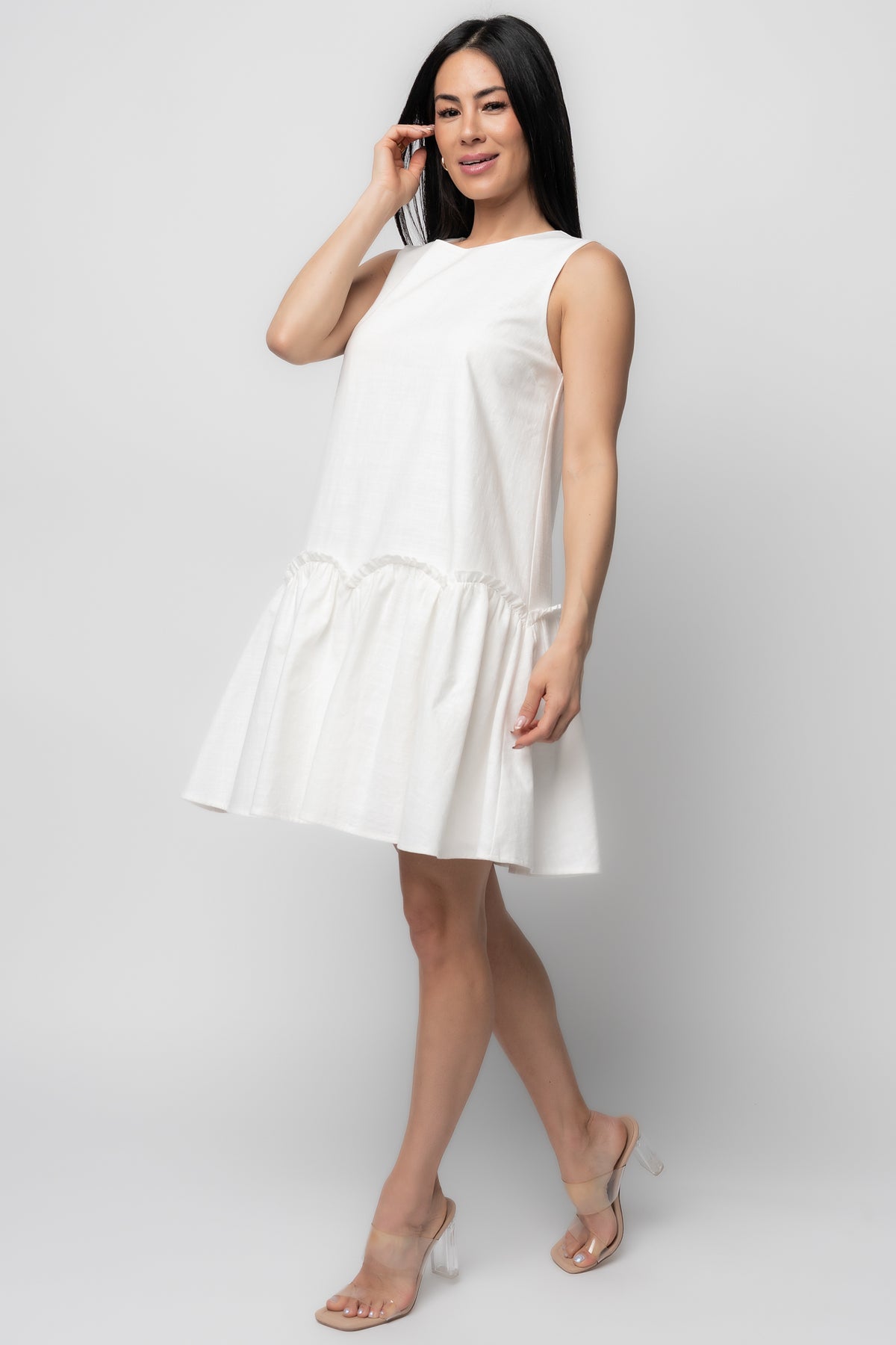 Close-up of Paulina Short Dress fabric and detailing, showing textured cotton surface, scalloped ruffle edge, and fully lined interior at hem.