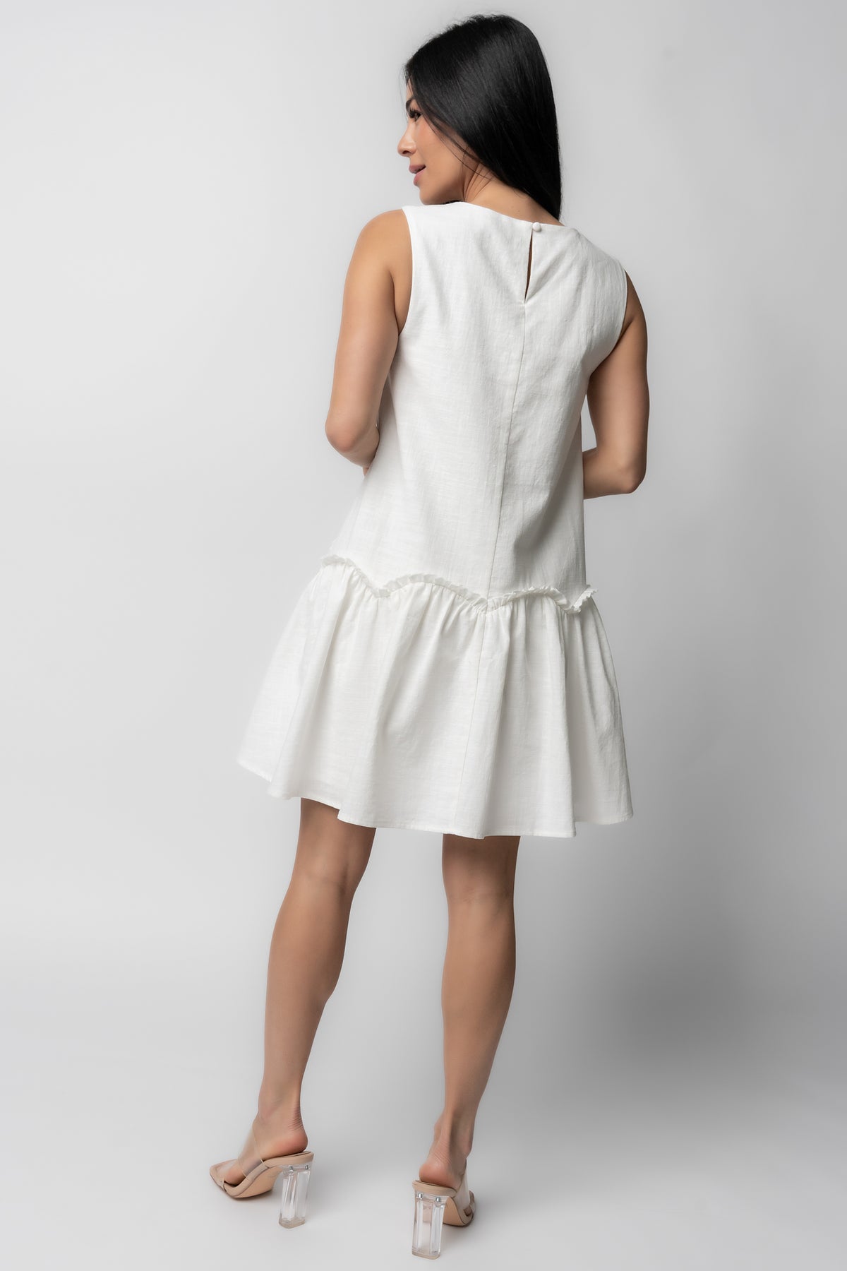 Back view of Paulina Short Dress in off-white, showing keyhole closure with button at nape and smooth, fully lined back panel for structure.