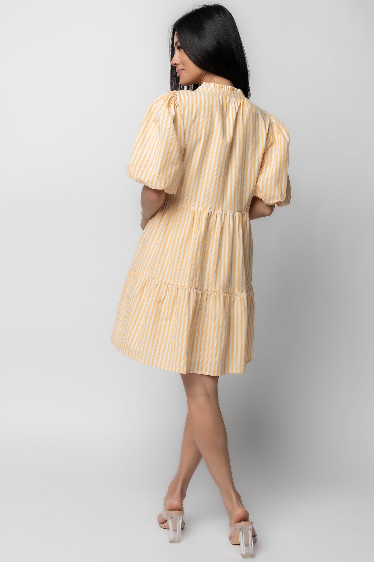 Detail of a hidden side pocket seam and skirt tiers on the Sadie Short Dress, showing construction and functional design in striped cotton.