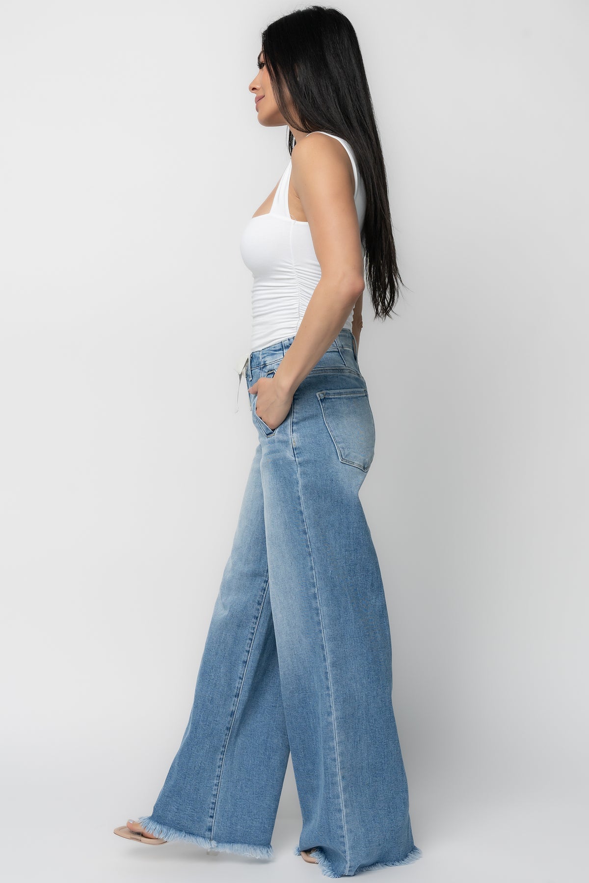 Close-up of fabric showing stretch denim composition (cotton blend) for shape retention, subtle texture, and mid-wash color depth.