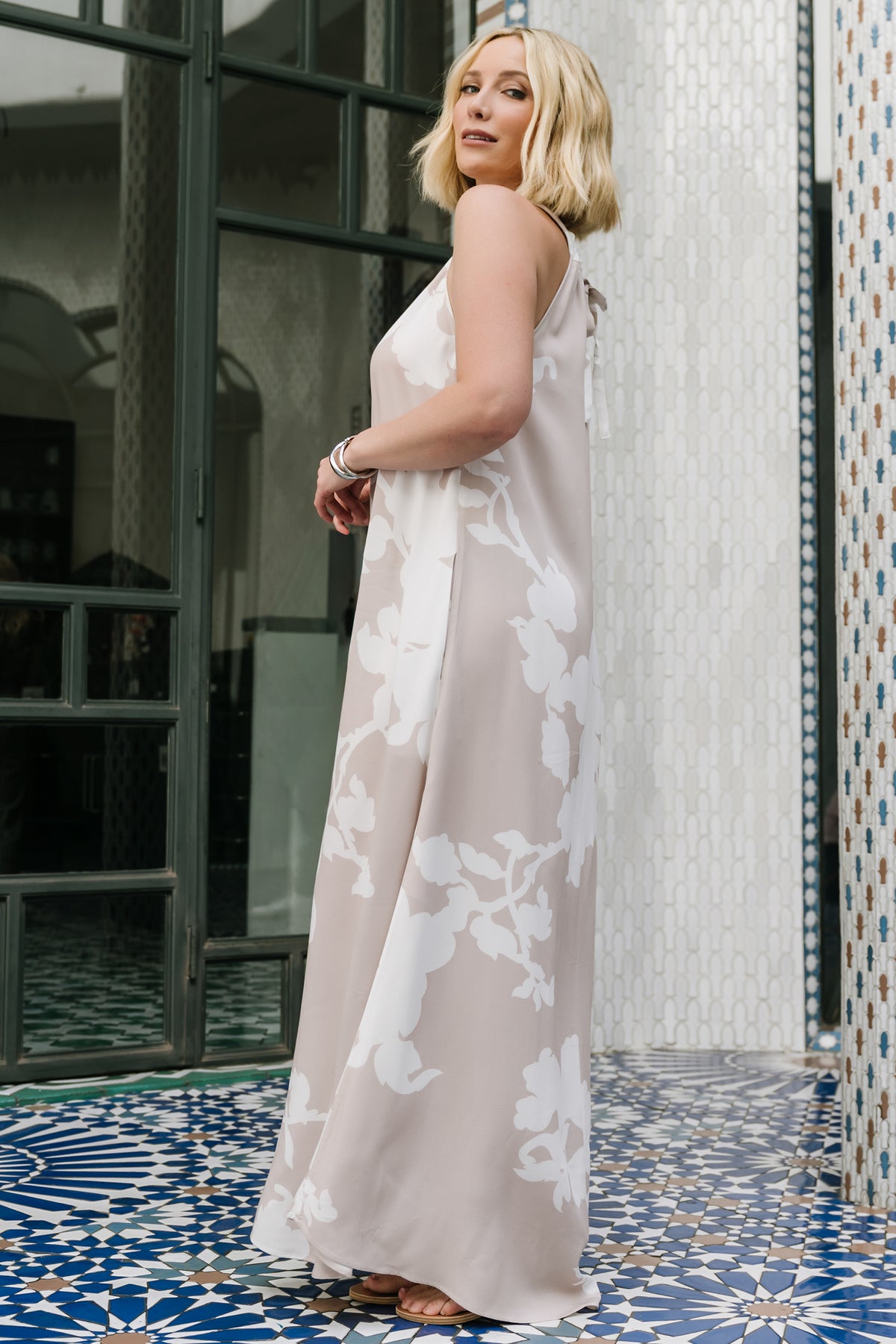 Full-length shot of the Aurelia Halter Maxi Dress in natural white print, highlighting unlined maxi skirt and column silhouette.