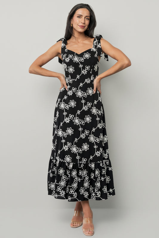 Front view of Amor Midi Dress in black with ivory embroidered floral appliqué, sweetheart neckline and three-tiered midi skirt.