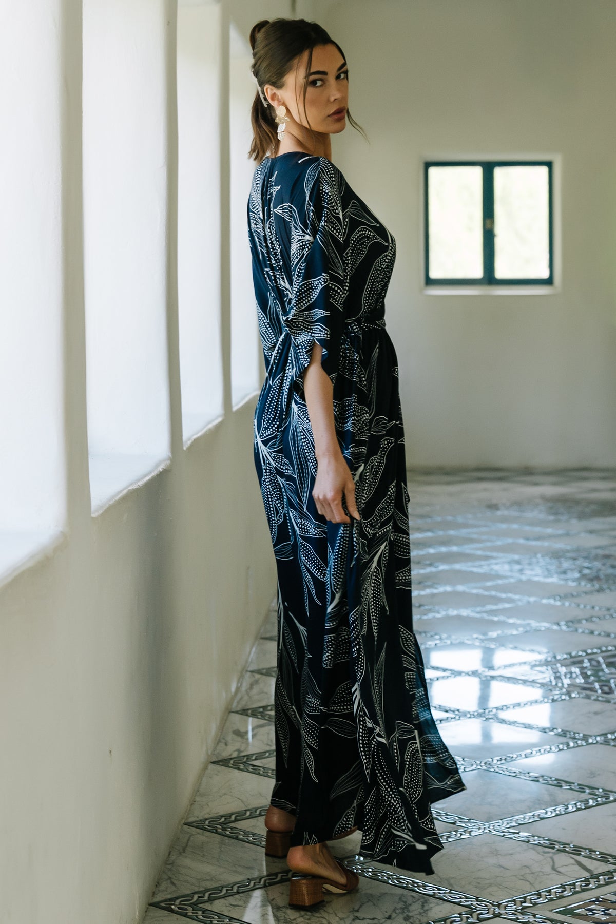 Close-up of fabric and print on Kalea dress highlighting navy background, off-white botanical pattern and soft rayon texture under studio lighting.