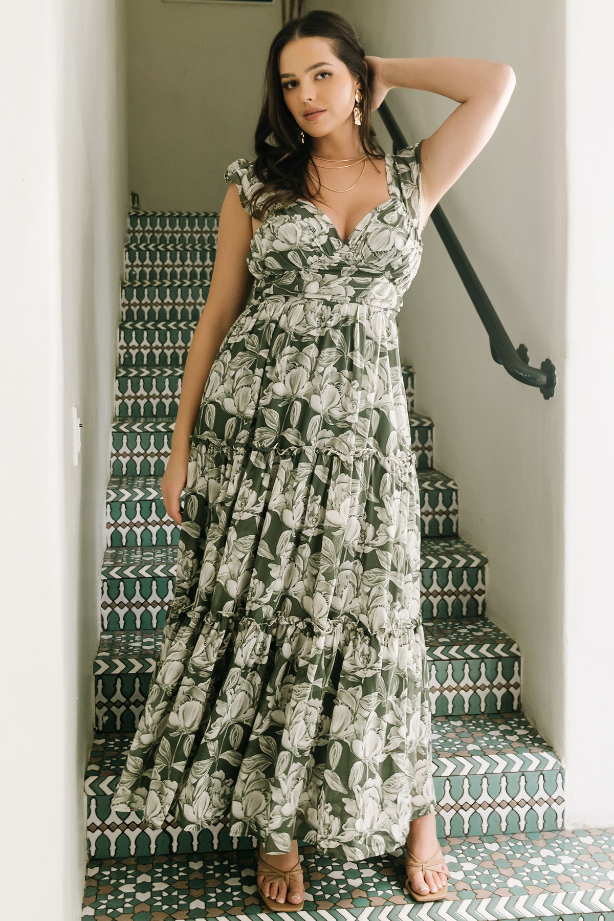 Model wearing Martina Maxi Dress in green and white floral chiffon styled with sandals to show true length, tiered movement and fit.