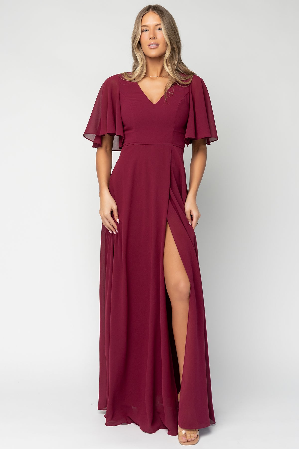 Detail shot of chiffon fabric texture and lining edge on the Valetta Maxi Dress in wine, showing 100% polyester finish and drape.