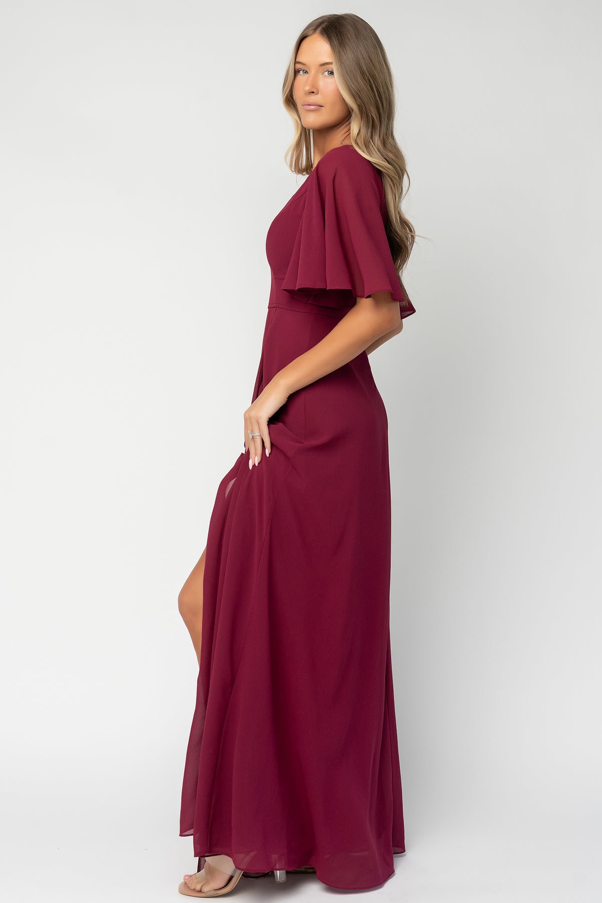 Close-up of the Valetta dress bodice showing delicate seams at the bodice, defined waist seam and flutter sleeve detail in wine chiffon.