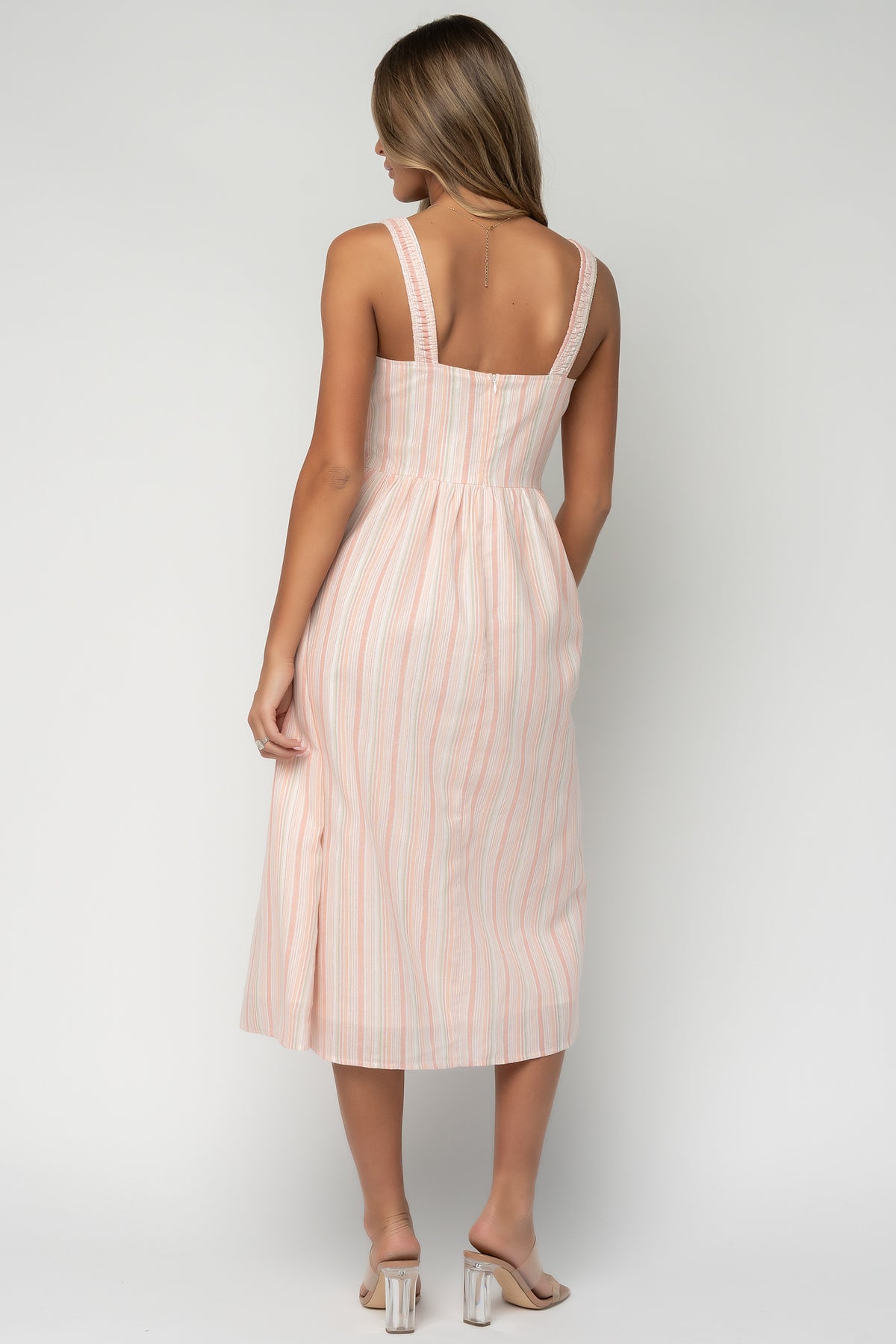 Styled look of Melina Midi Dress paired with neutral sandals, illustrating the dress's relaxed silhouette, midi hem and suitability for outdoor events and wedding guest wear.