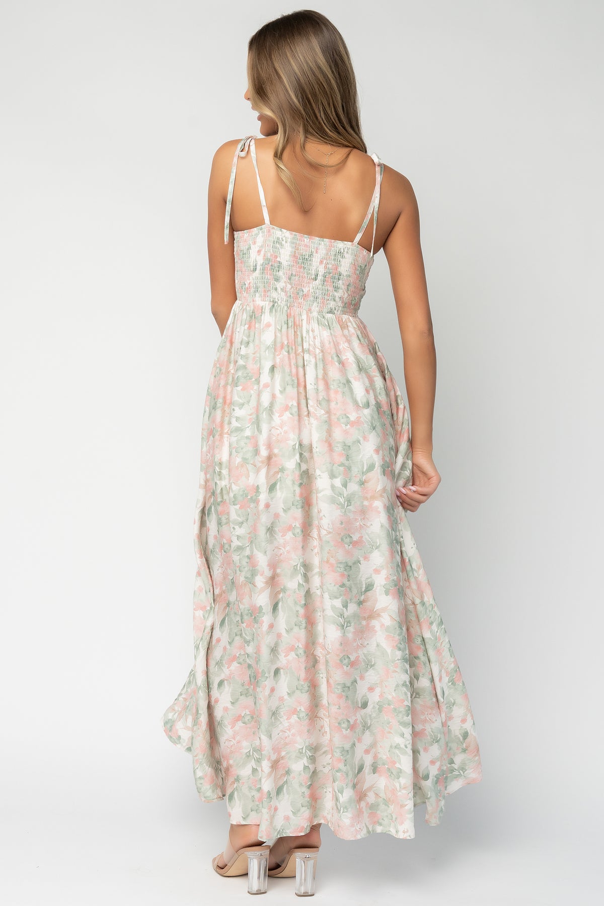 Side view of Elton Maxi Dress worn by model, revealing hidden side pocket placement and elegant silhouette with mid-thigh lining coverage.