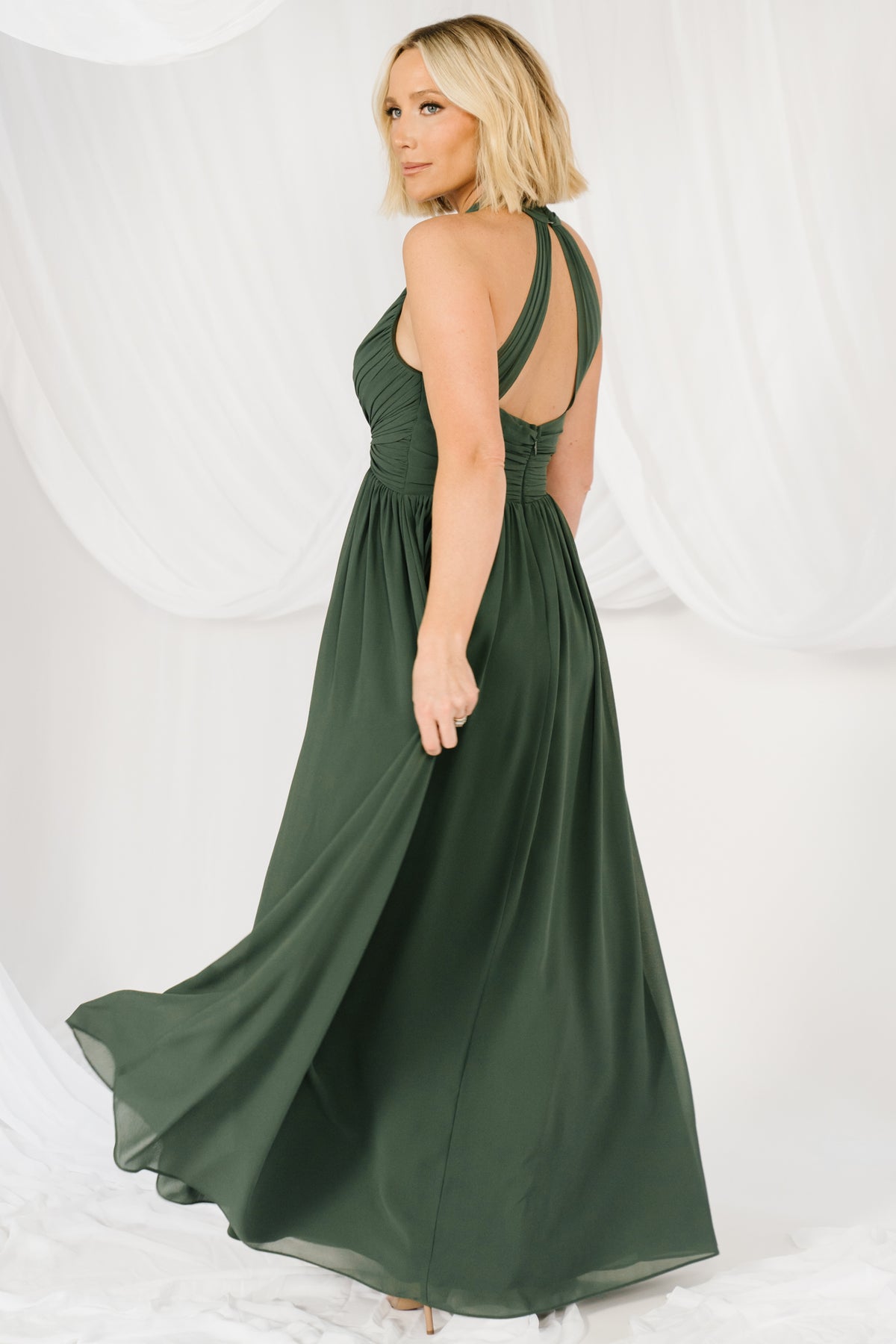 Close-up of twisted bust knot and pleated front bodice on the Larissa halter maxi in cypress green, highlighting fabric texture and detail.