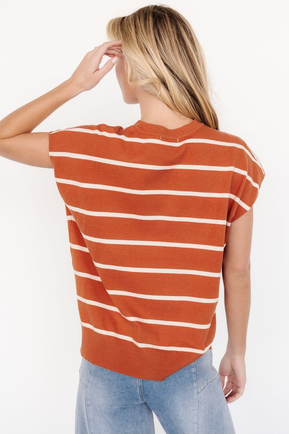 Rear view of Ada Dolman top highlighting hem ribbing and gentle drape of the lightweight sweater knit in sandstone and natural stripes.