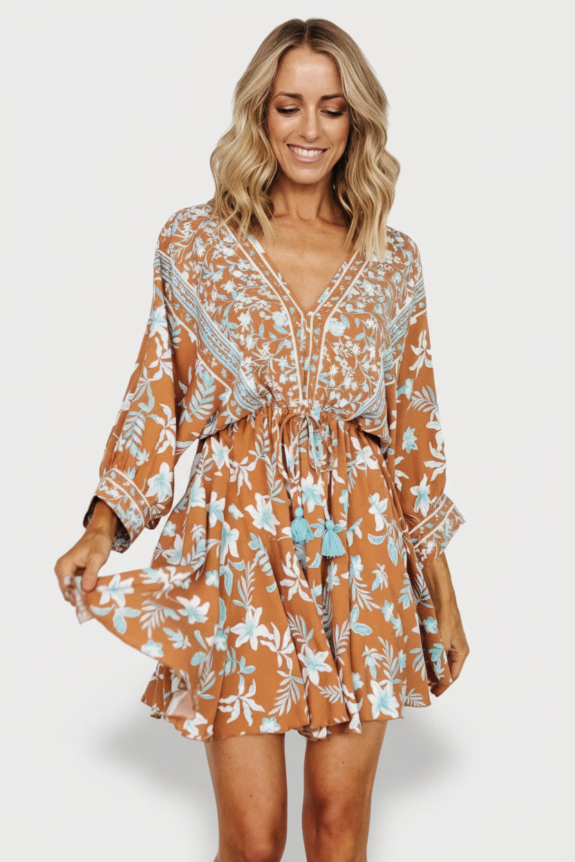 Detail shot of ruffle hem and skirt movement on the Adria Mini Dress, camel and blue floral rayon fabric.