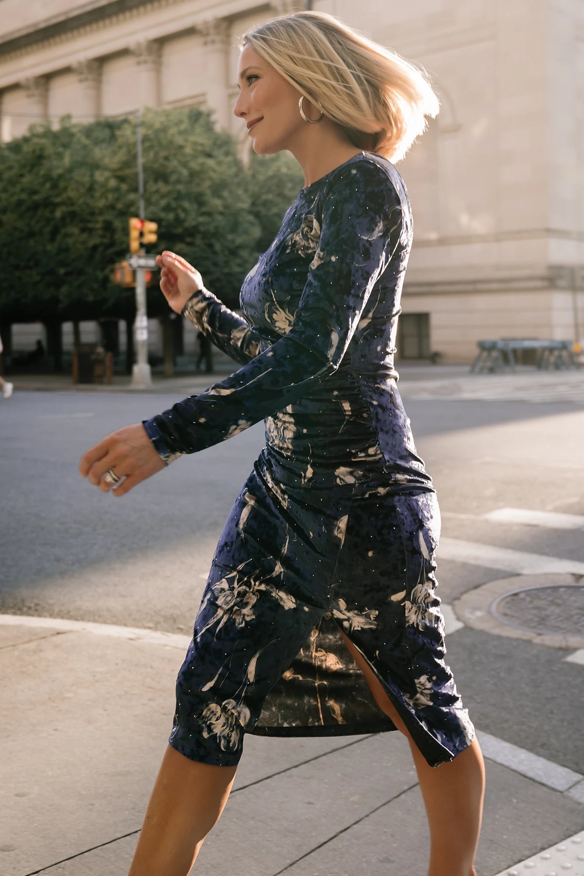 Afterglow Velvet Midi Dress in Navy + Gold with metallic florals, boat neckline, long sleeves, and side draping.