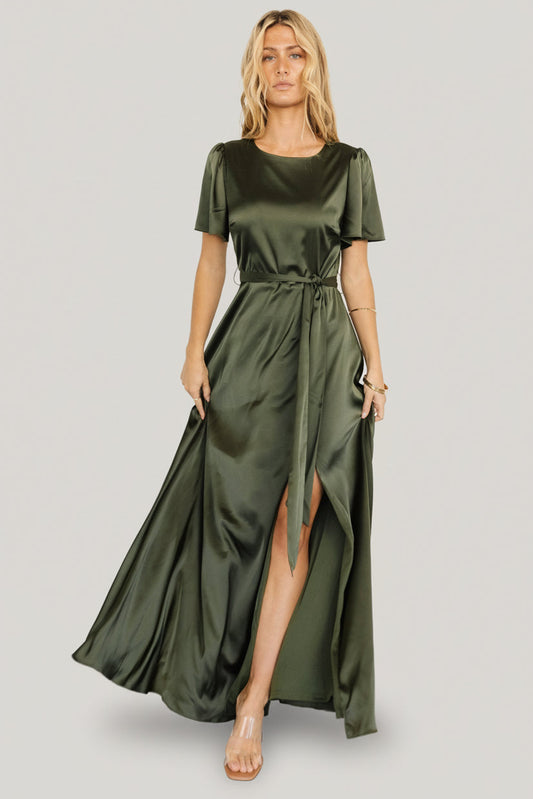 Front view of Agnes satin maxi dress in juniper green on model, showing rounded neckline and removable waist tie, full-length drape.