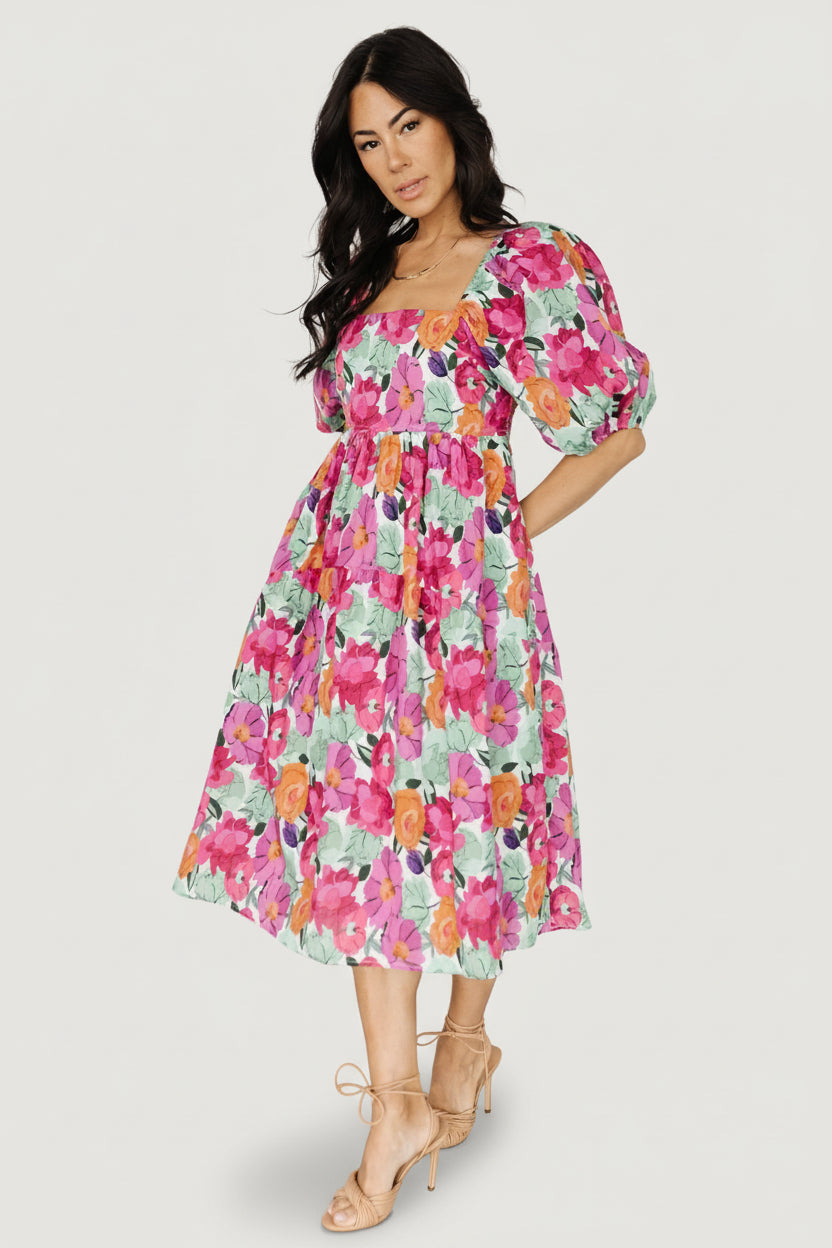 Back view close-up of the smocked back bodice and elasticated shoulders on the Aimee puff sleeve midi dress in pink multi floral print.