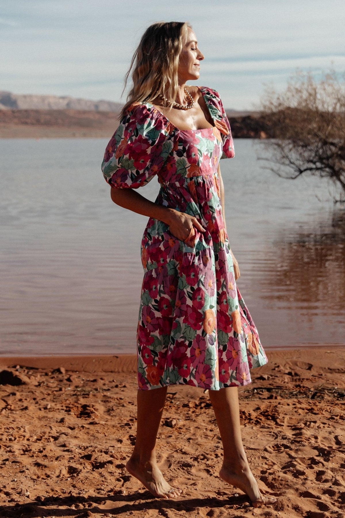 Studio view of the Aimee dress in pink multi highlighting the lined skirt, puff sleeve profile, and gathered waist for an elevated, feminine look.