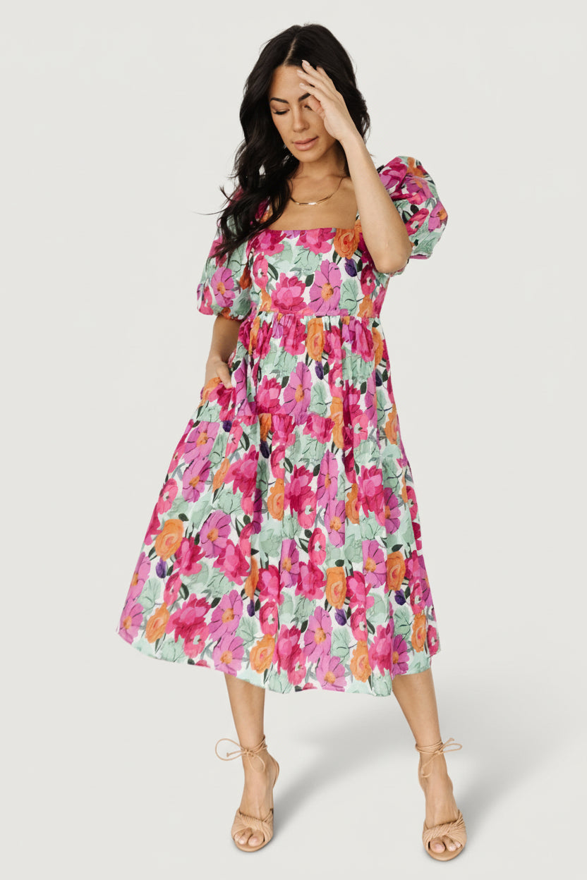 Model wearing the Aimee Puff Sleeve Midi Dress in pink multi, demonstrating the mid-calf length, square neckline and relaxed silhouette.