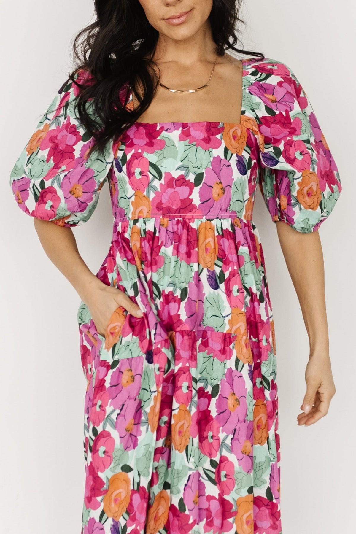 Close-up of gathered waist and side pocket on the Aimee puff sleeve midi dress, illustrating functional pocket and fabric texture in pink multi.