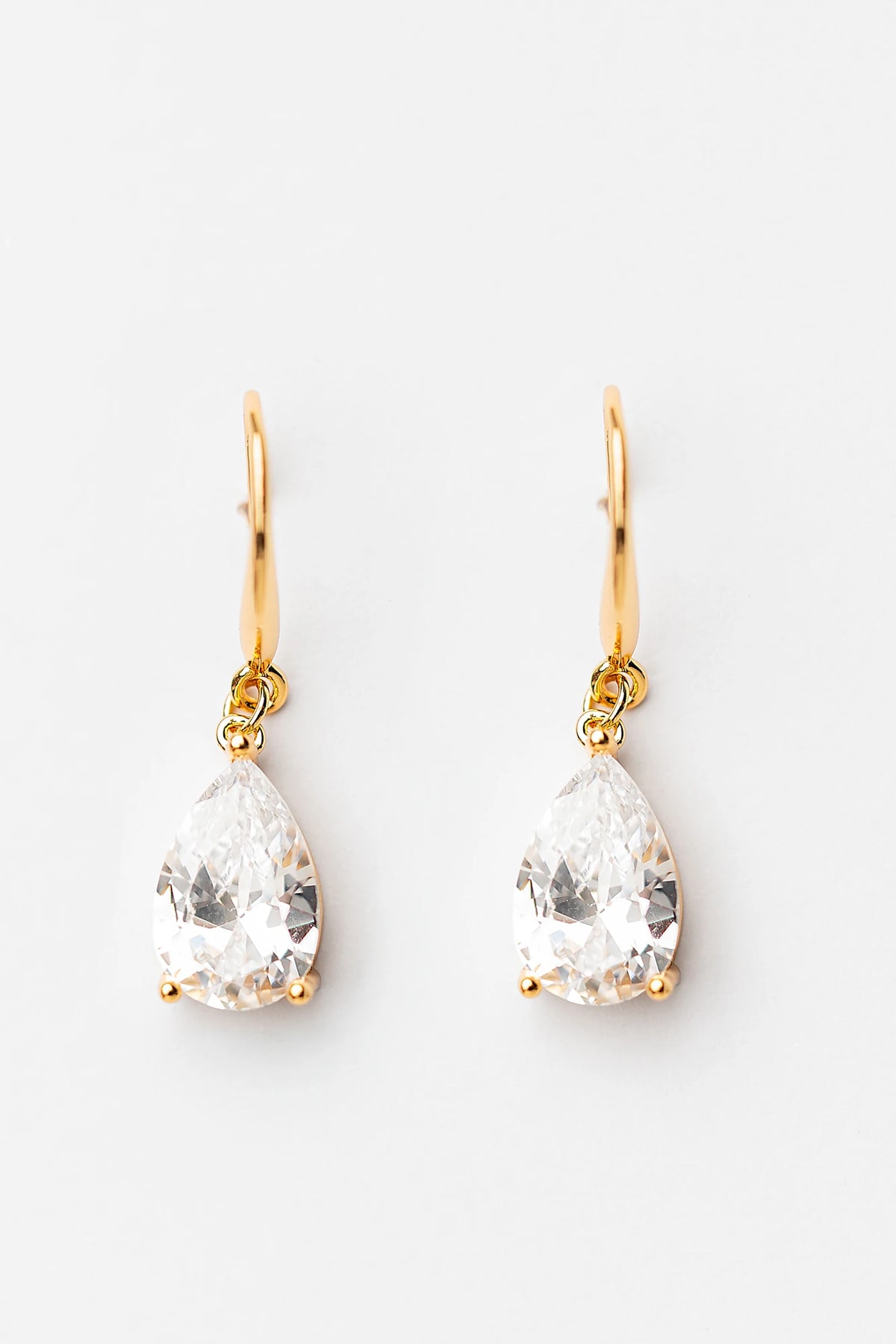 Aira Teardrop Earrings in Gold with clear teardrop stone and sleek hook design.