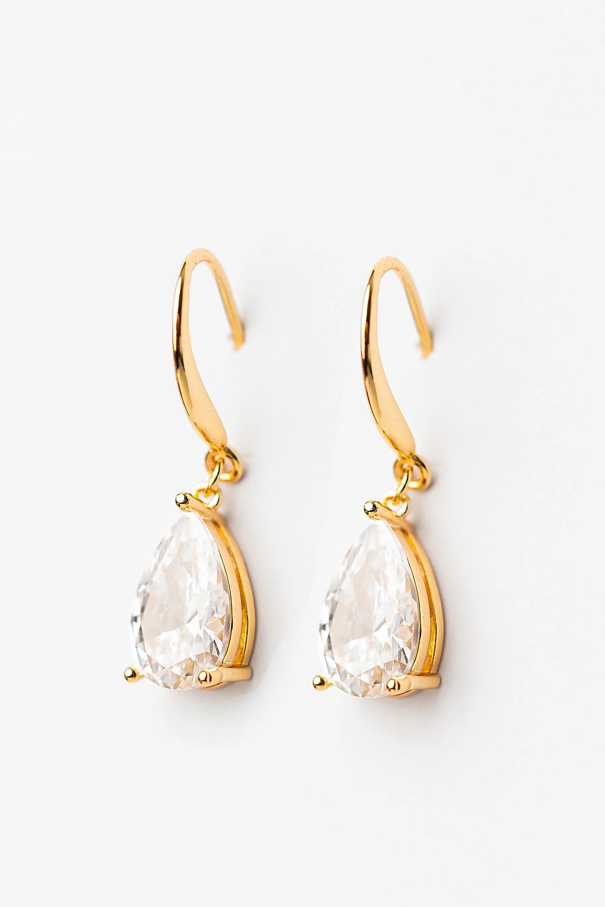 Aira Teardrop Earrings in Gold with clear teardrop stone and sleek hook design.
