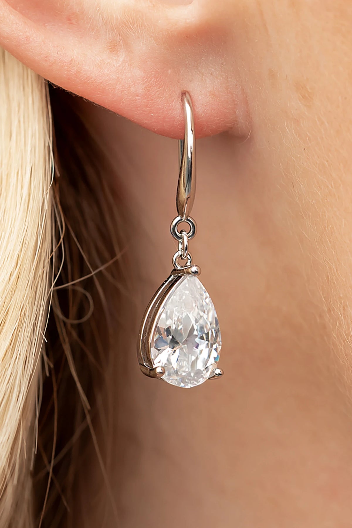 Aira Teardrop Earrings in Silver with clear teardrop stone and sleek hook design.