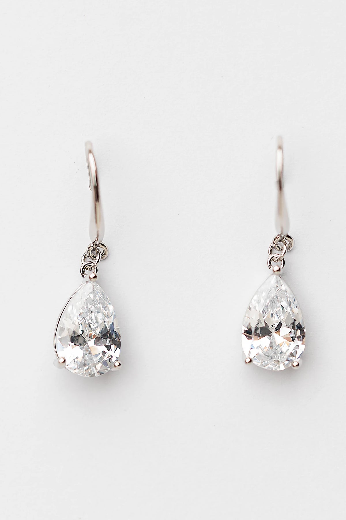 Aira Teardrop Earrings in Silver with clear teardrop stone and sleek hook design.