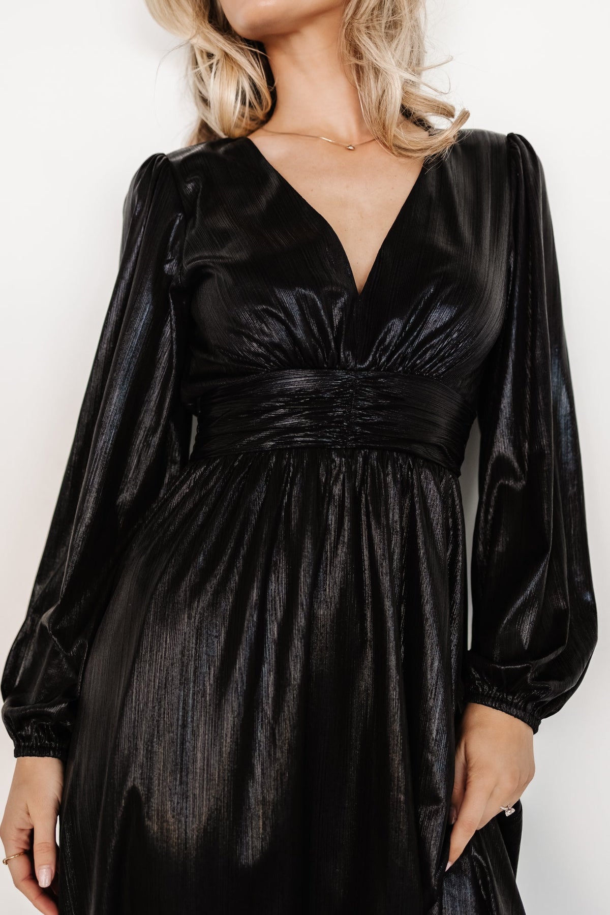 Close-up of the Aisha Shimmer Dress bodice showing gathered waist details, smocked back panel, and subtle metallic shimmer texture.