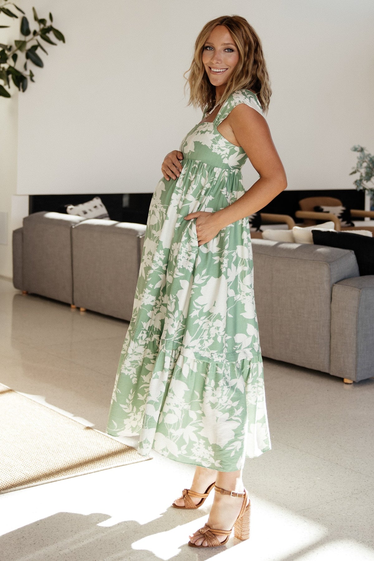 Detail shot of textured fabric and floral print on the maxi dress, showing weave, color contrast between green and ivory, and fabric weight.