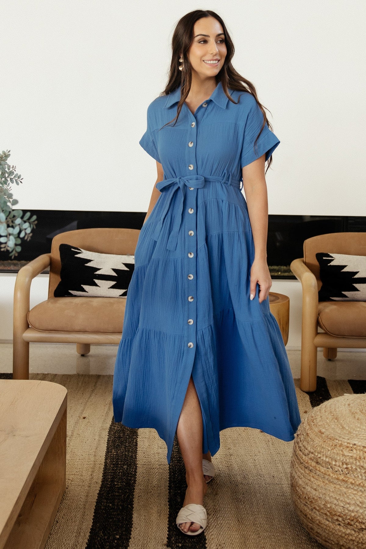 Side view of Aizey maxi dress in ocean blue highlighting hidden side pockets, self-tie sash and flowing tiered A-line skirt.