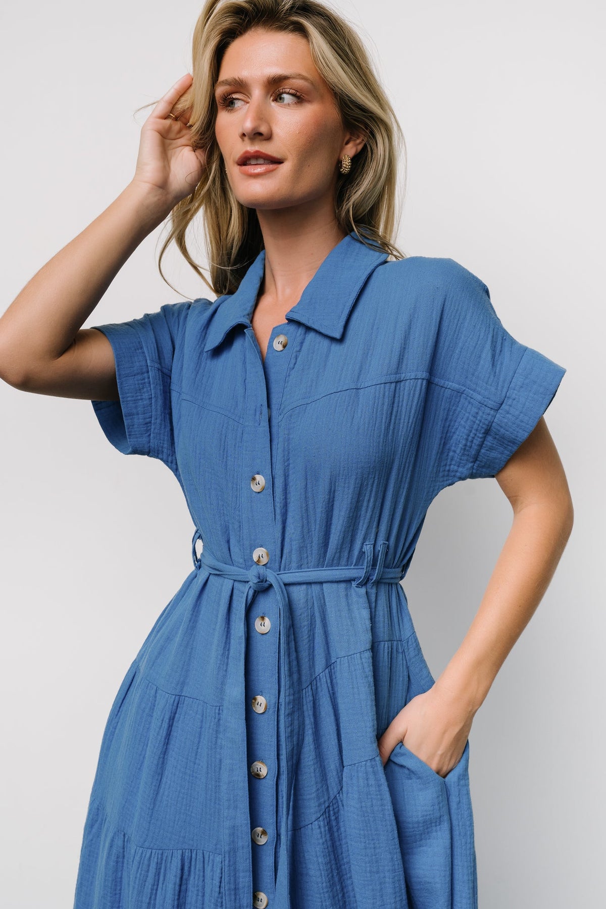Back and angled view of the blue Aizey maxi dress showing tiered diagonal seams and lightweight unlined cotton construction.
