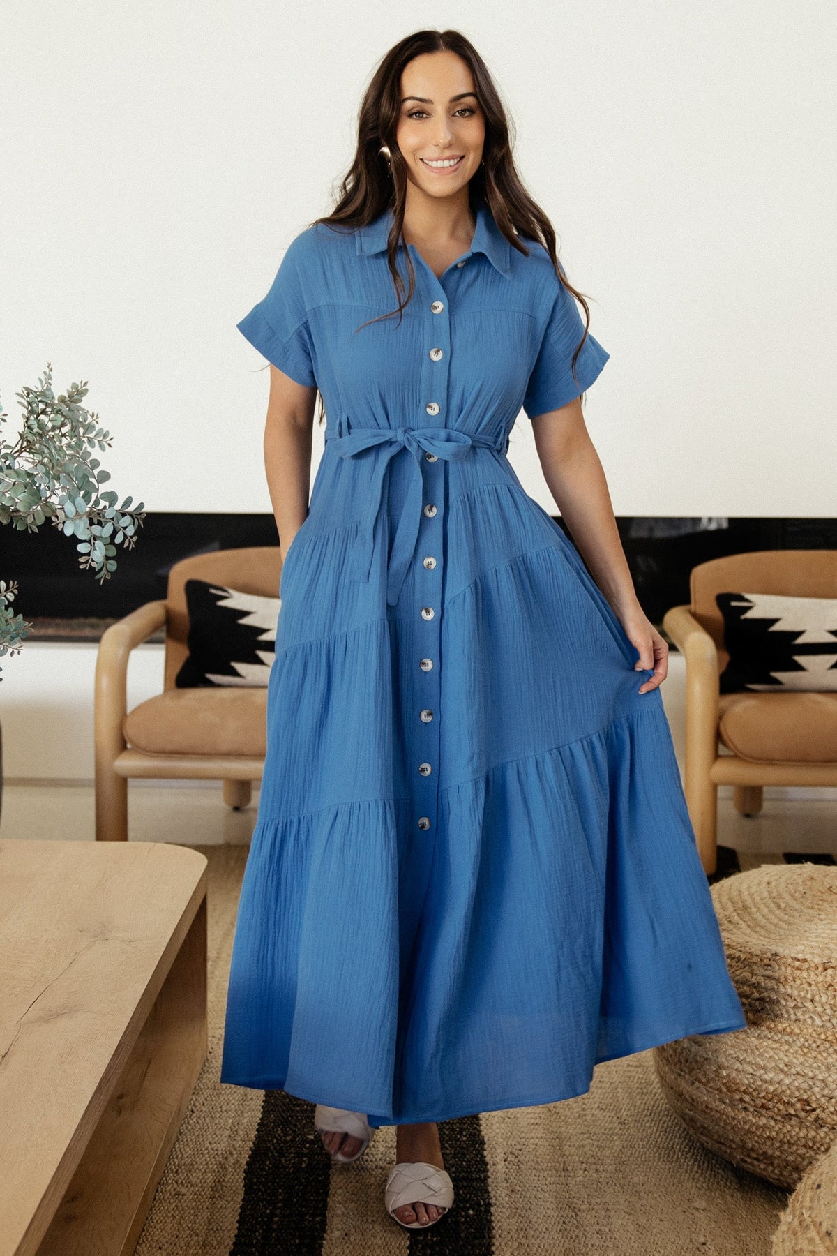 Model walking in Aizey blue maxi dress, illustrating skirt movement, A-line silhouette, and textured cotton drape.