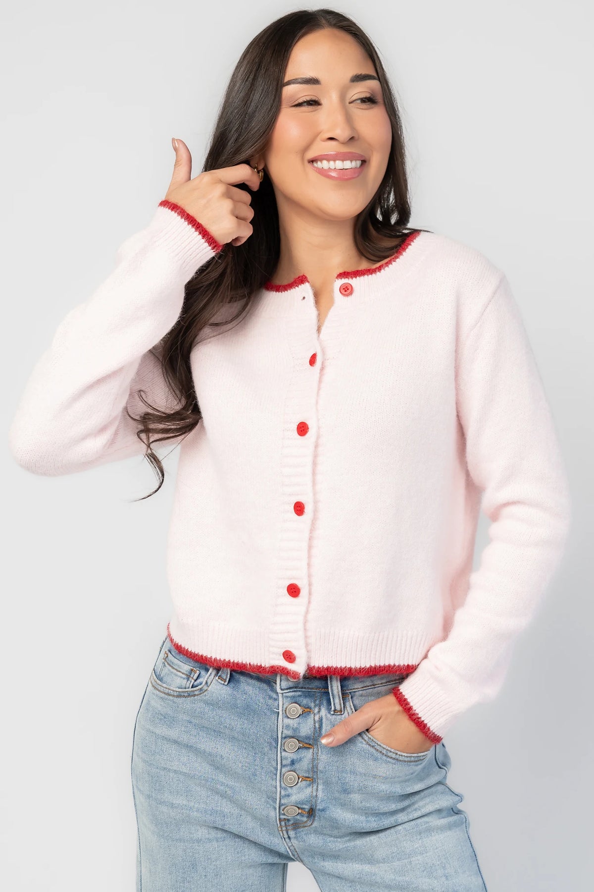 Alanna Cardigan in Blush + Red with contrasting red trim, crew neckline, red button front, and ribbed knit details.