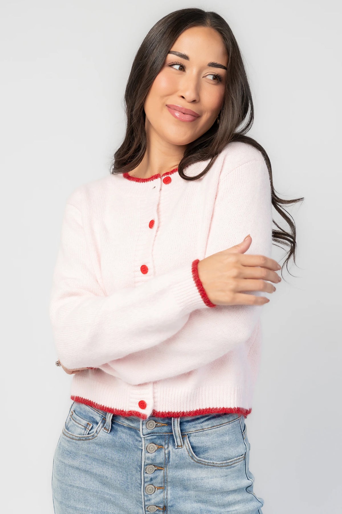 Alanna Cardigan in Blush + Red with contrasting red trim, crew neckline, red button front, and ribbed knit details.