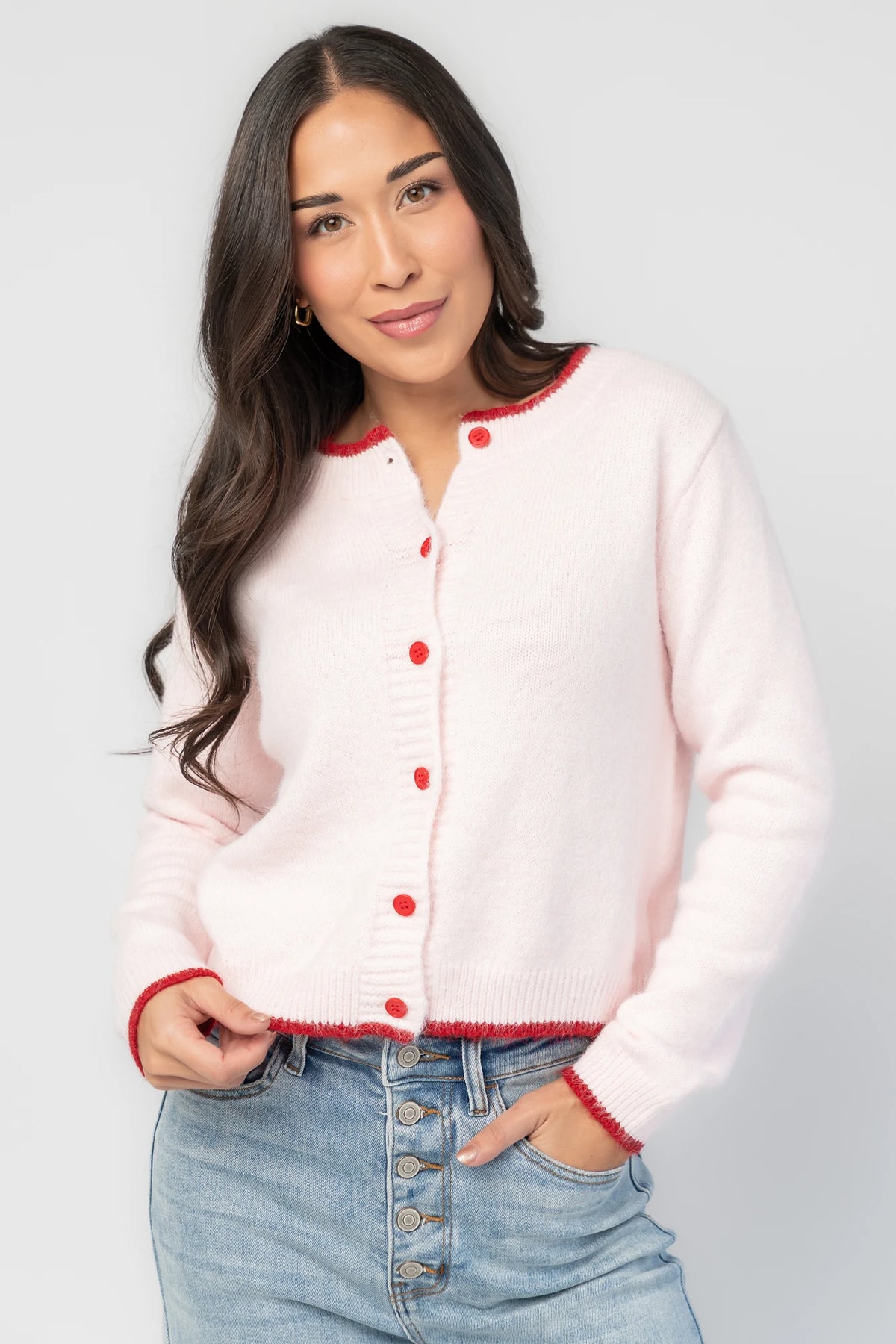 Alanna Cardigan in Blush + Red with contrasting red trim, crew neckline, red button front, and ribbed knit details.