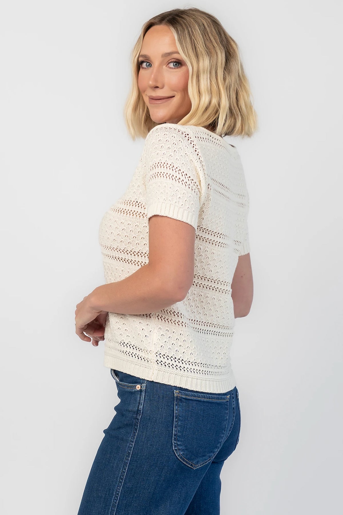 Albon Open Knit Top in Cream with V-neckline, open knit texture, and ribbed trim.