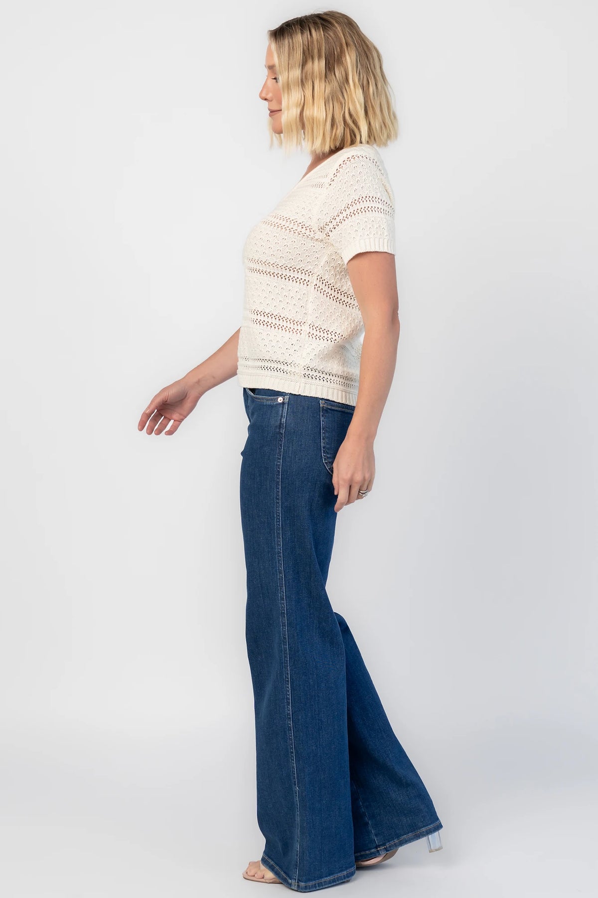 Albon Open Knit Top in Cream with V-neckline, open knit texture, and ribbed trim.