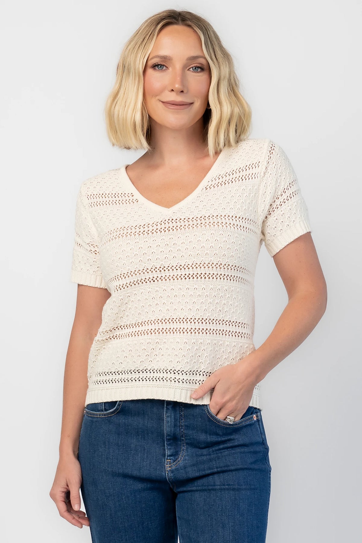 Albon Open Knit Top in Cream with V-neckline, open knit texture, and ribbed trim.