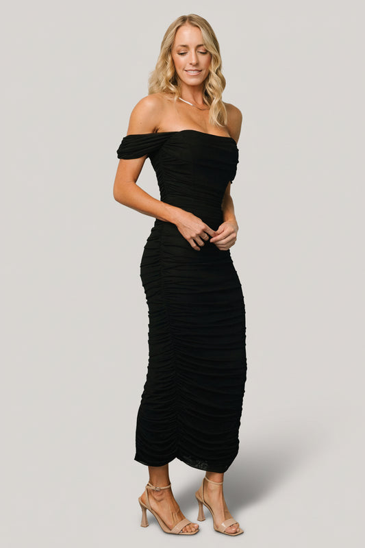 Front view of Alessandra black mesh midi dress on model showing off‑shoulder neckline, structured bust, ruched sides and fitted midi silhouette for evening wear.