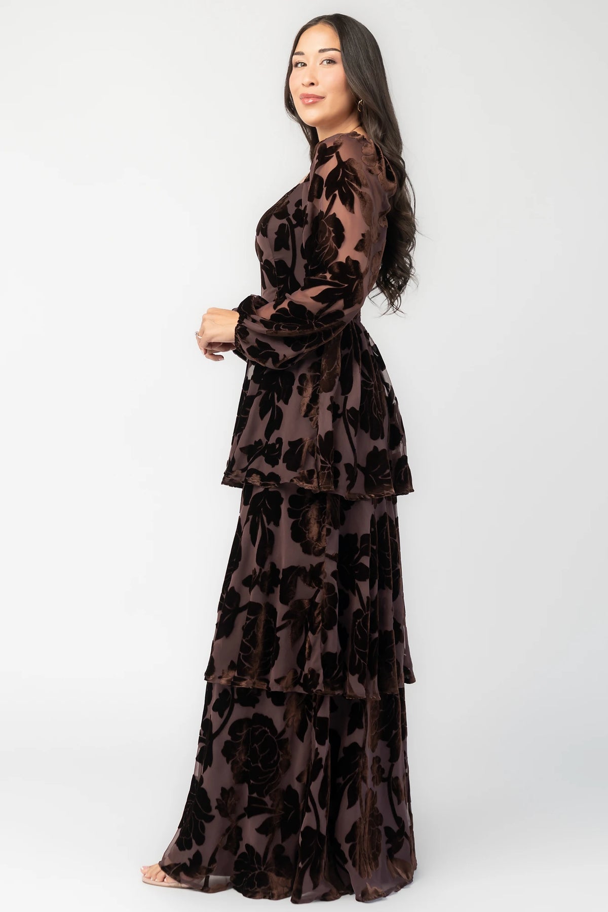 Alexandra Velvet Maxi Dress in Dark Brown with velvet florals, sweetheart neckline, long sleeves, smocked back, and flowing skirt.